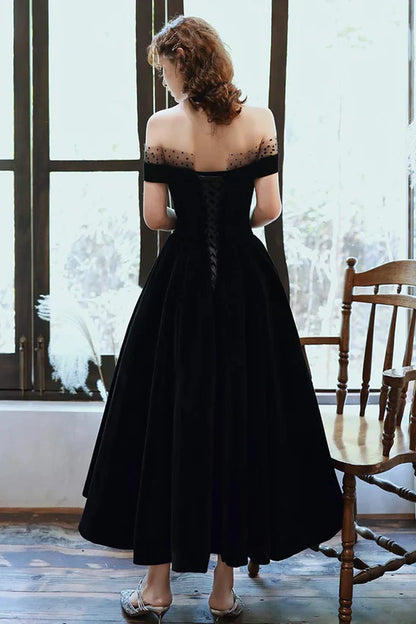Back view of the off-shoulder black velvet evening dress.