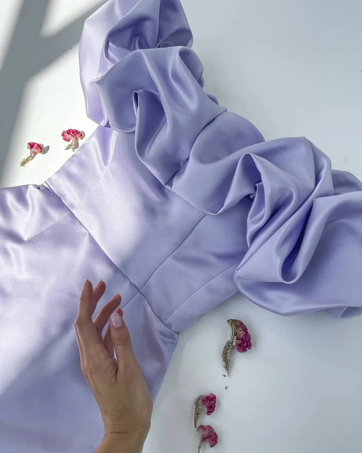 Full length view of a model posing in the lilac off-shoulder bodycon dress.