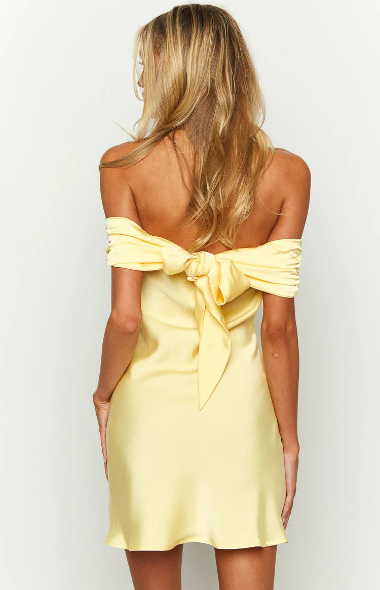Close-up of the off-shoulder neckline detail of the mini dress.