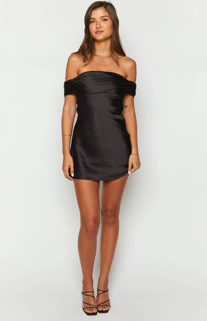 Model posing in the elegant off-shoulder mini dress for homecoming.
