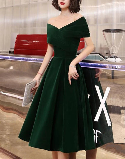 Green velvet off-shoulder dress, side view.