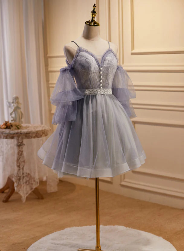 Close-up of the lace and tulle fabric on the off-shoulder party dress.