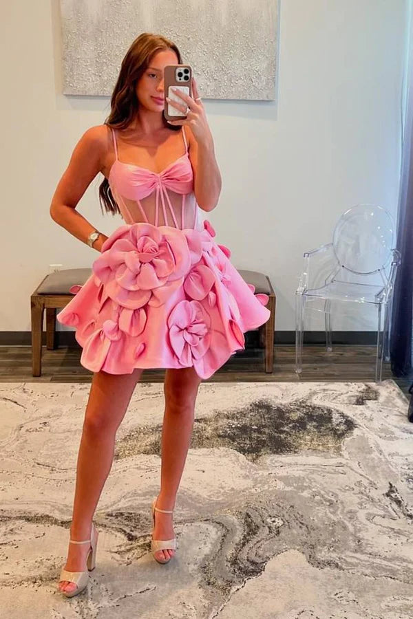 Pink A-line satin homecoming dress with spaghetti straps and floral details.