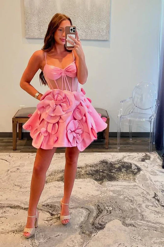 Pink A-line satin homecoming dress with spaghetti straps and floral details.