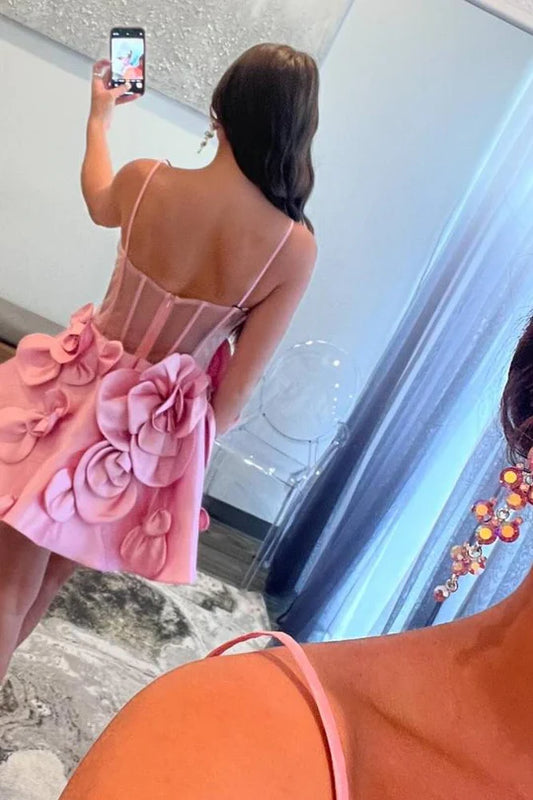 Back view of a pink A-line satin homecoming dress with spaghetti straps.