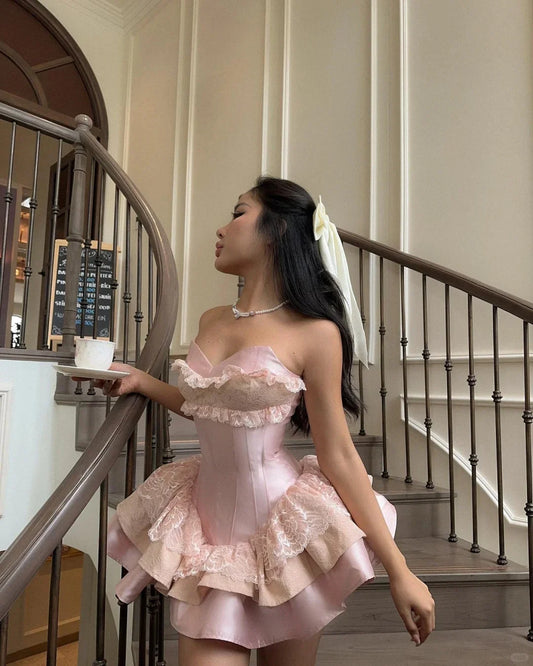 Pink strapless corset homecoming dress with lace ruffled layered skirt.