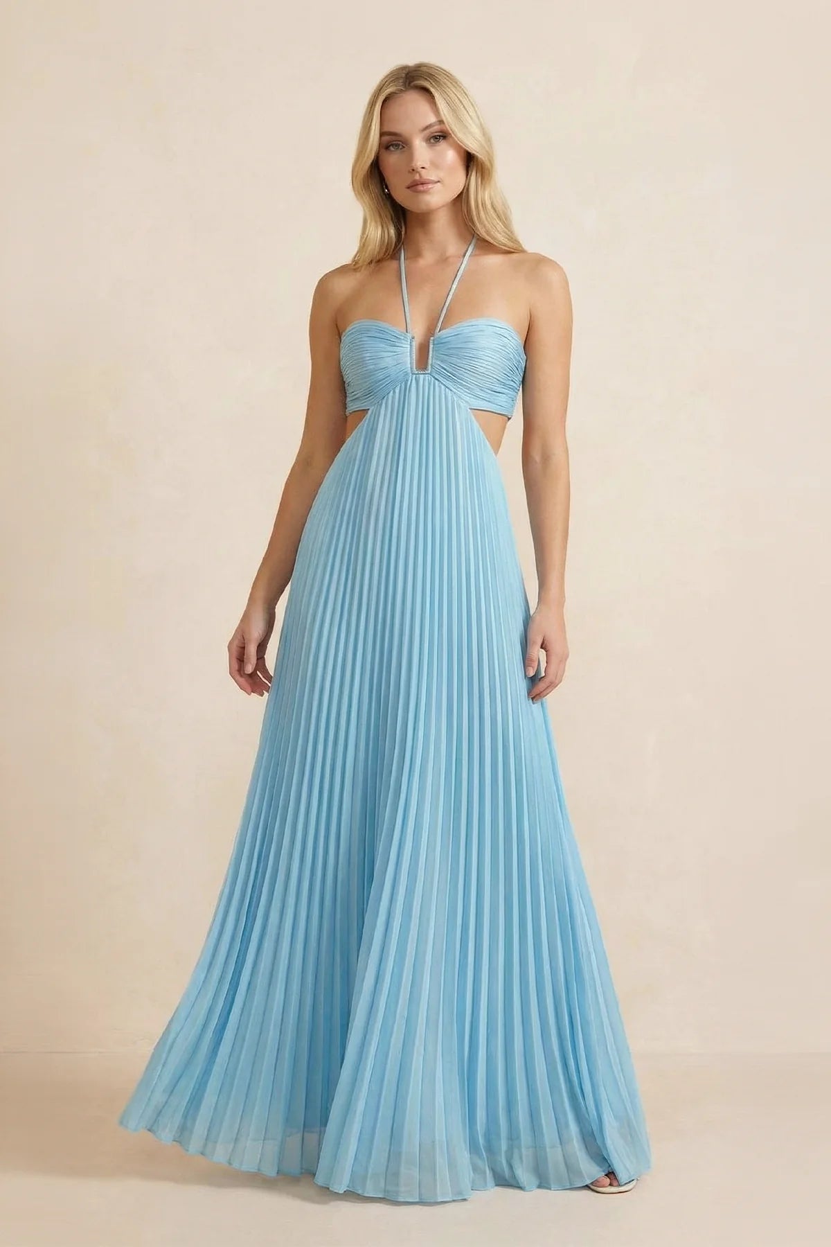 Elegant halter neck pleated chiffon gown with waist cut-outs and tie-back.