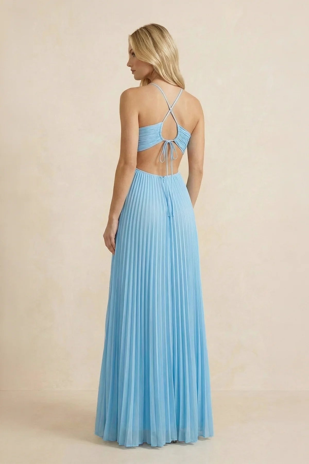Back view of a flowing pleated chiffon formal dress with tie-back detail.
