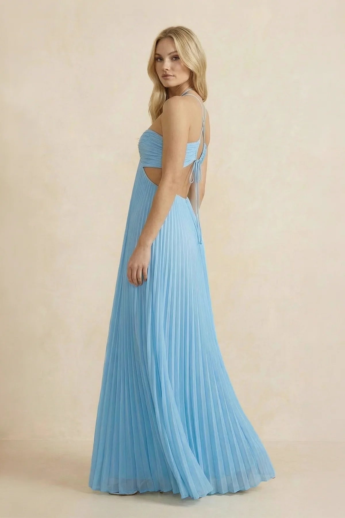 Side view of a floor-length halter neck prom dress in pleated chiffon.