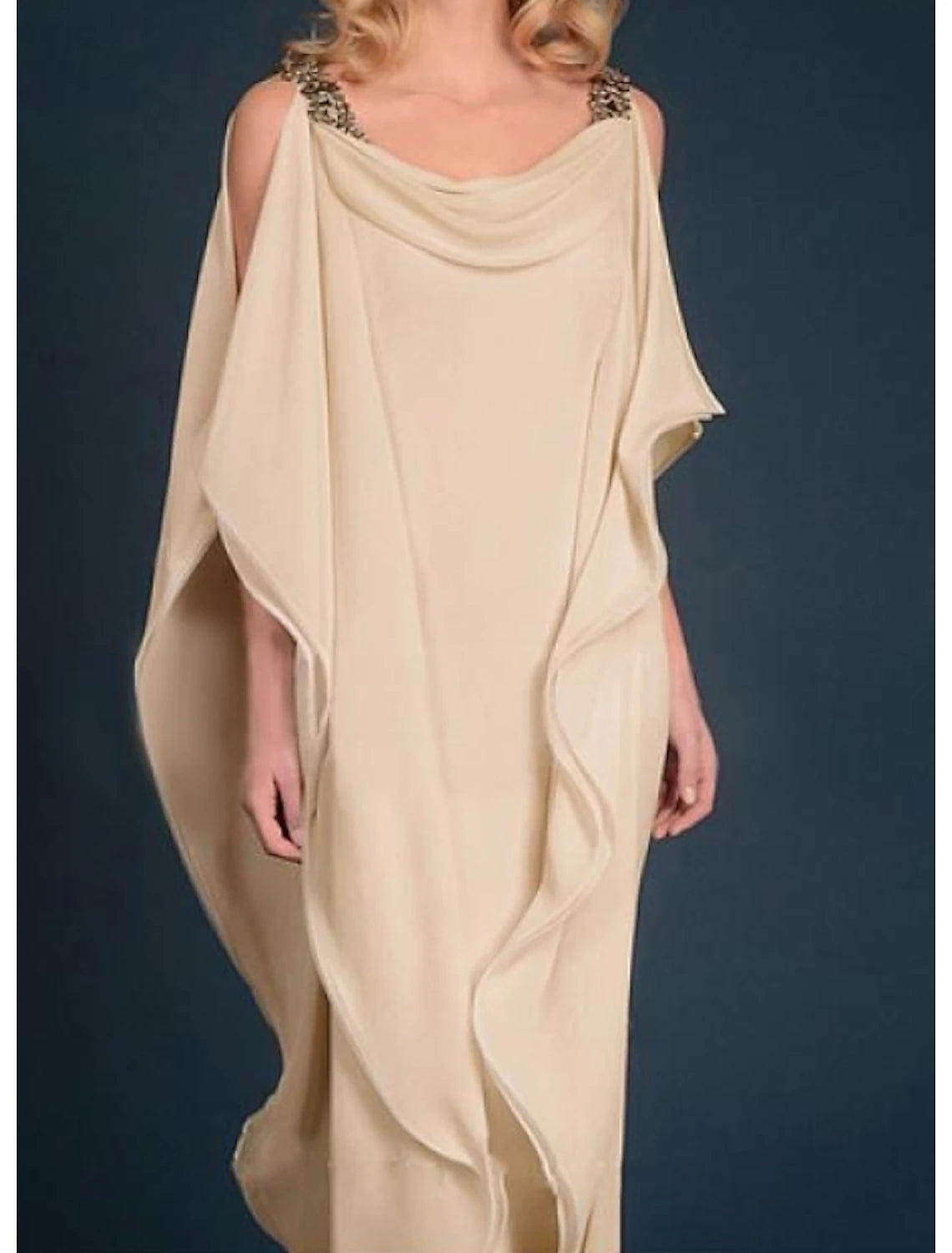 Elegant plus size woman in a dark jewel neck chiffon gown with half sleeves and beading.