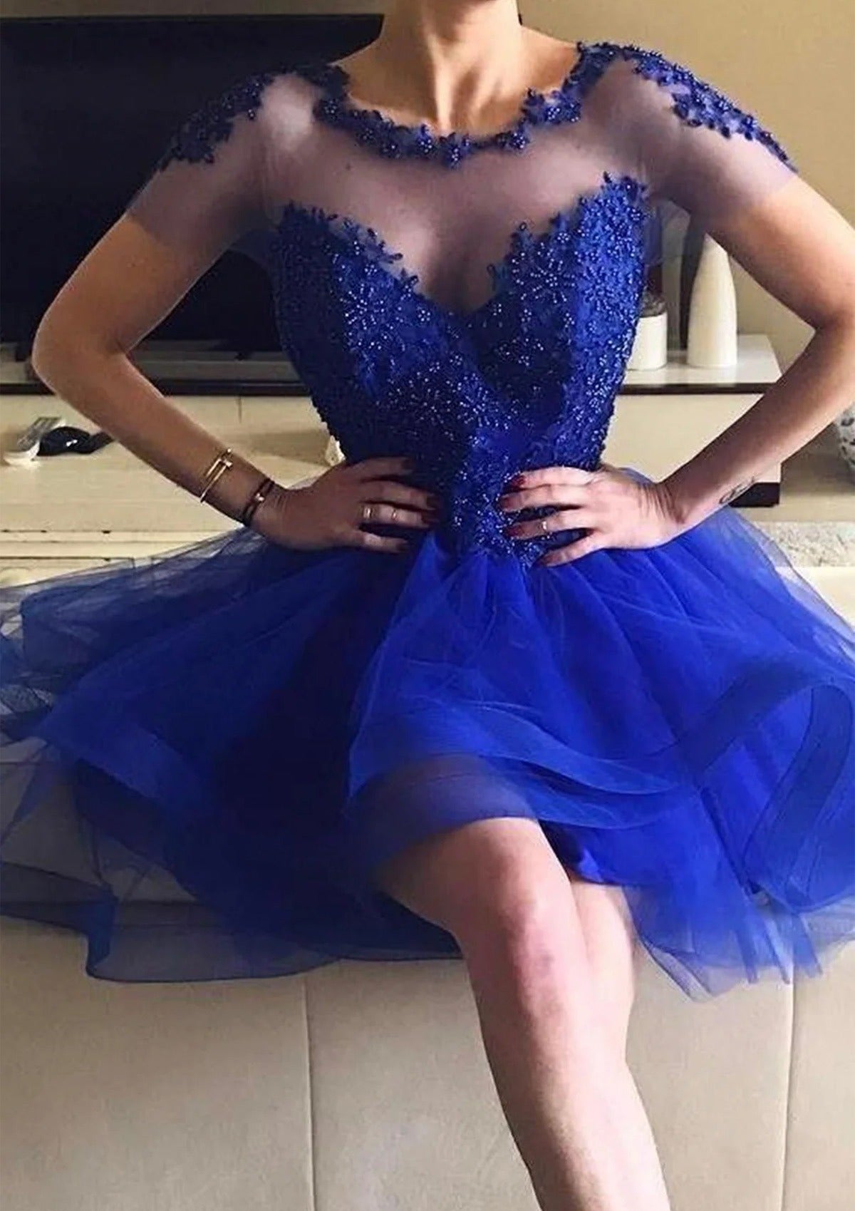 Royal blue A-line high-low homecoming dress with sheer neck and beaded lace bodice.