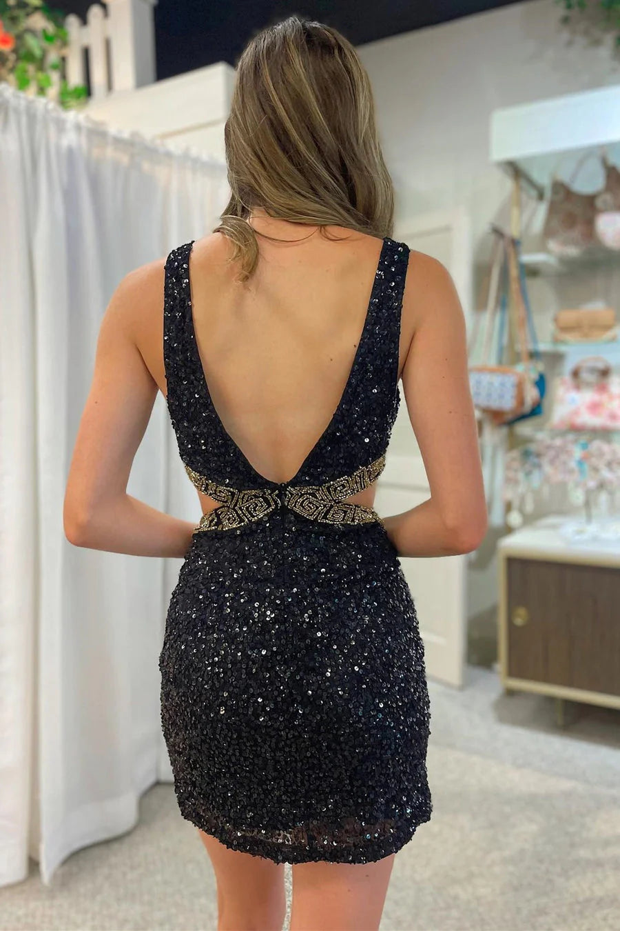 Close-up of the black sequin and beaded V-neck dress with cutout details.