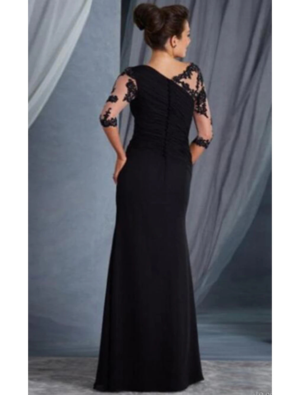 Close-up of the lace appliques and jewel neckline on the elegant evening gown.