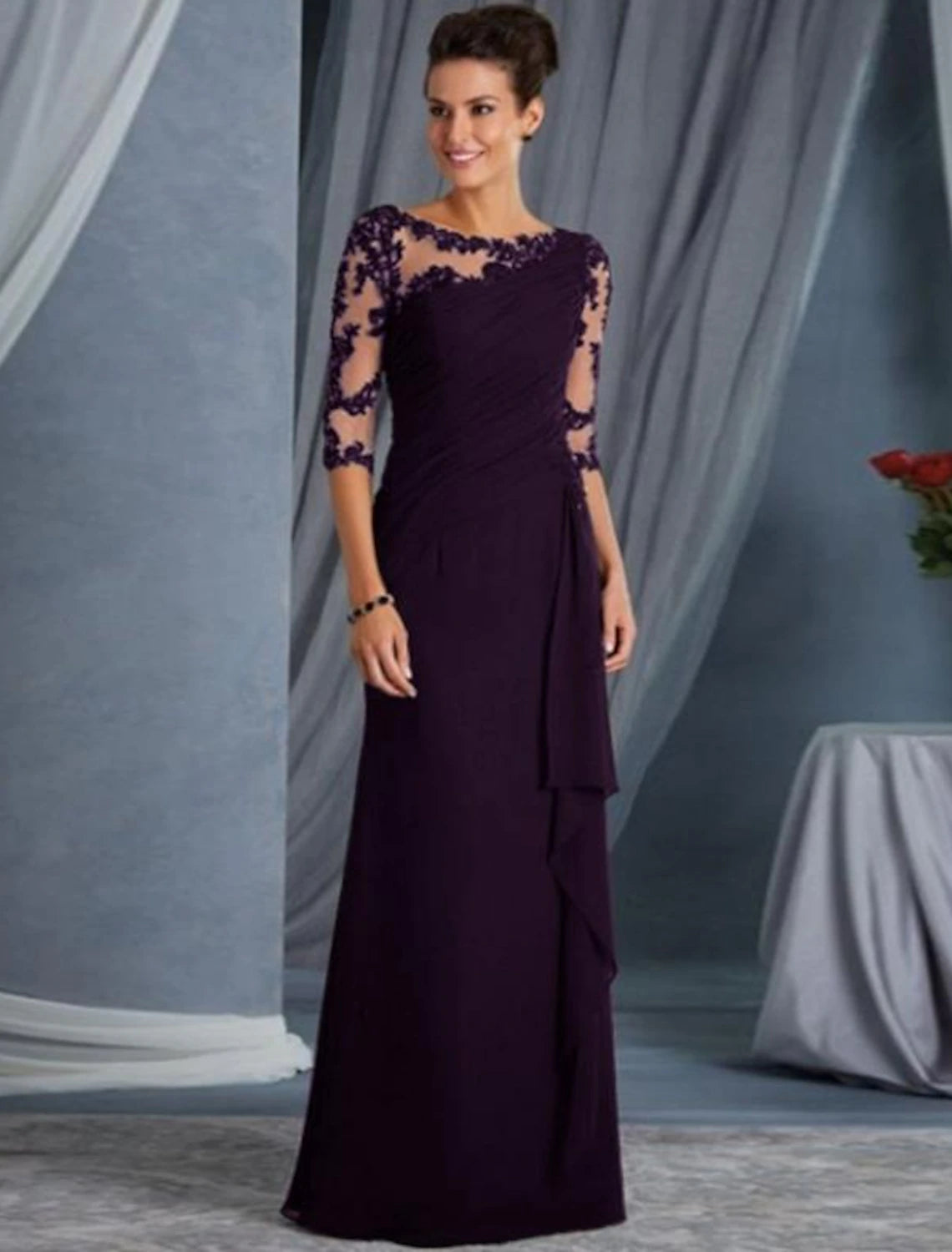 Back view of the floor-length sheath gown, highlighting its elegant silhouette.