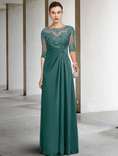Woman in a navy sheath mother of the bride dress with jewel neck and short sleeves.