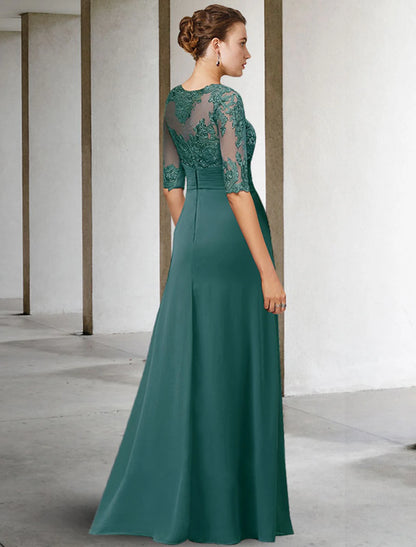 Close-up of the jewel neckline and intricate lace appliques on the navy gown.