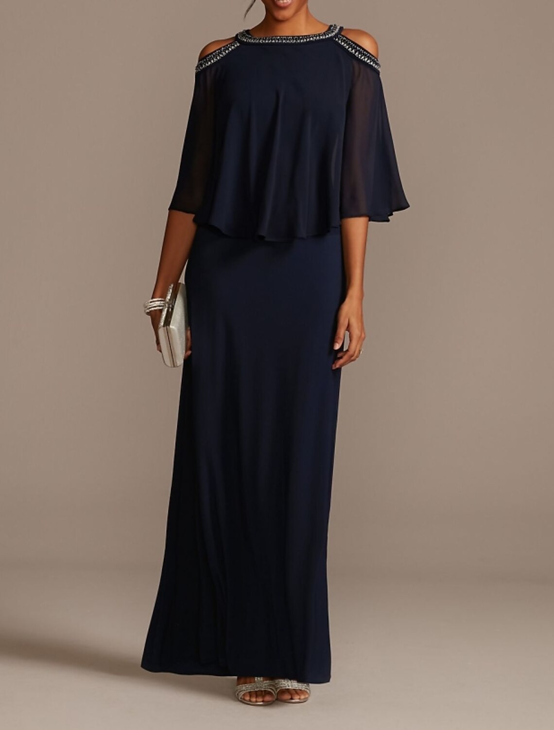 Woman wearing an elegant navy sheath Mother of the Bride gown.