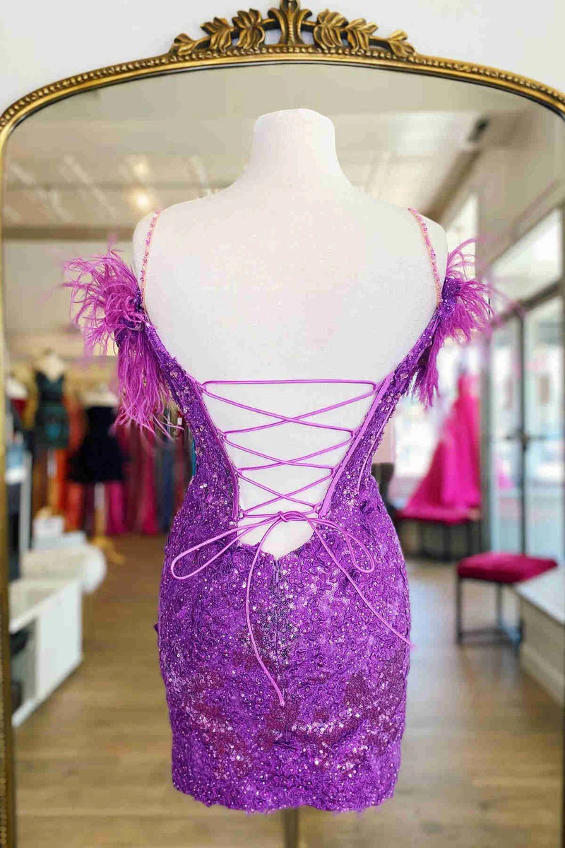 Close-up of the delicate lace and feather embellishments on the dress.