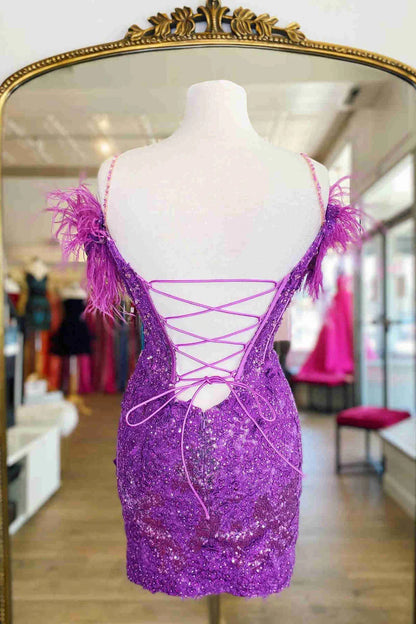 Close-up of the delicate lace and feather embellishments on the dress.