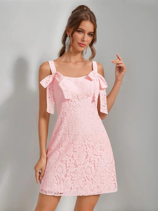 Model wearing a white lace mini sheath dress with square neckline and back bow.