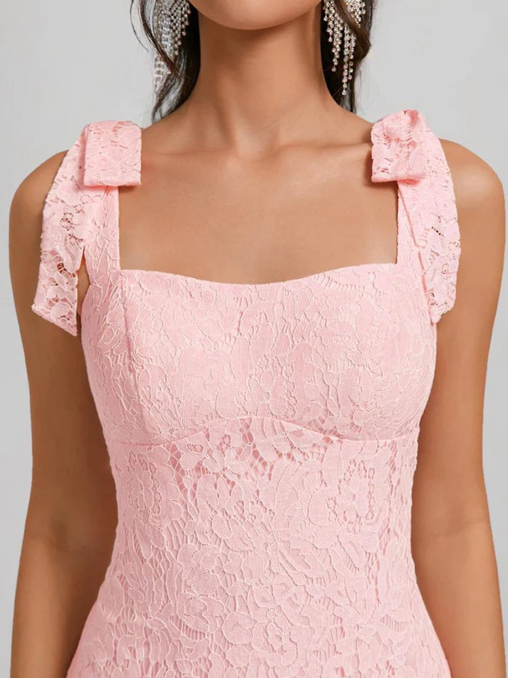 Side profile of white lace mini sheath dress, showcasing the fitted silhouette.