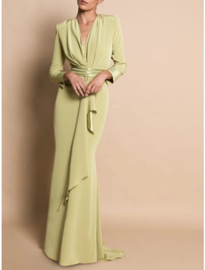Elegant V-neck long sleeve sheath dress with draping and ruching.