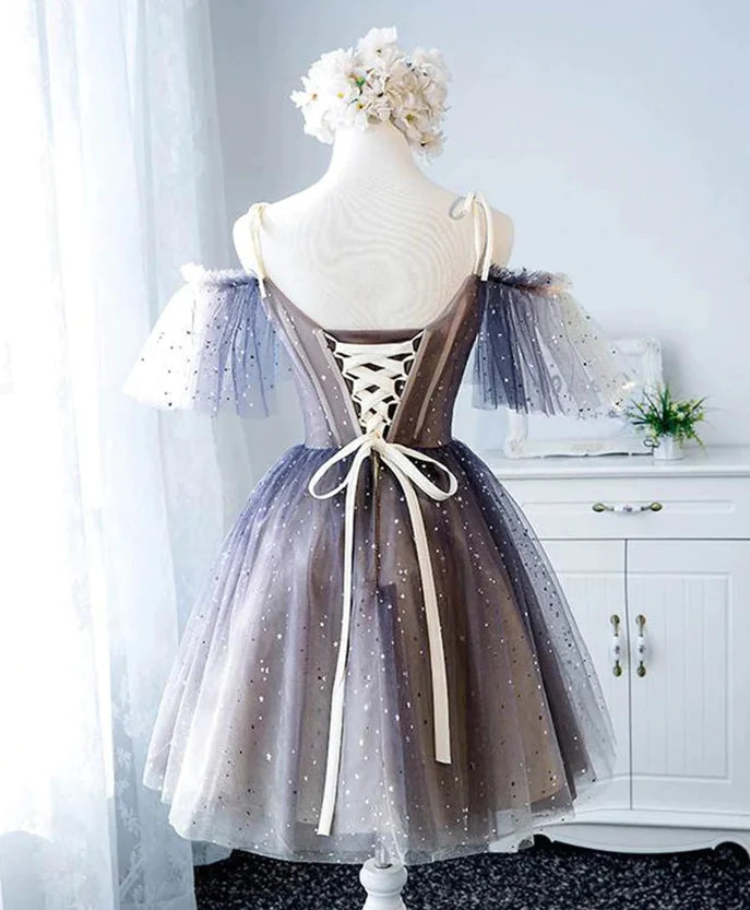 Back view of a model in a short tulle and lace homecoming dress.