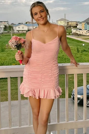 Close-up of the ruched detailing and ruffles on a short dress.