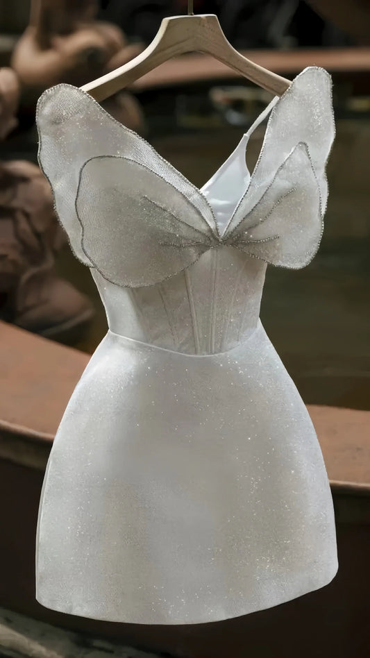 Sparkly white short homecoming dress with a large bowknot detail.