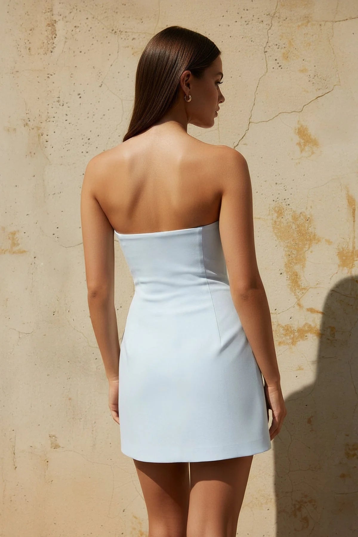Back view of the strapless bodycon mini dress with 3D rose details.