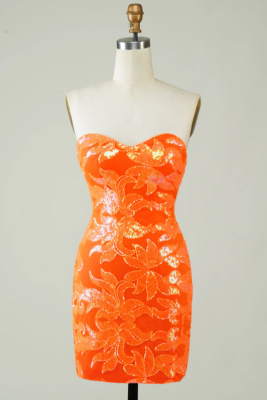 Model wearing an orange strapless bodycon knee-length homecoming dress with a lace-up back.