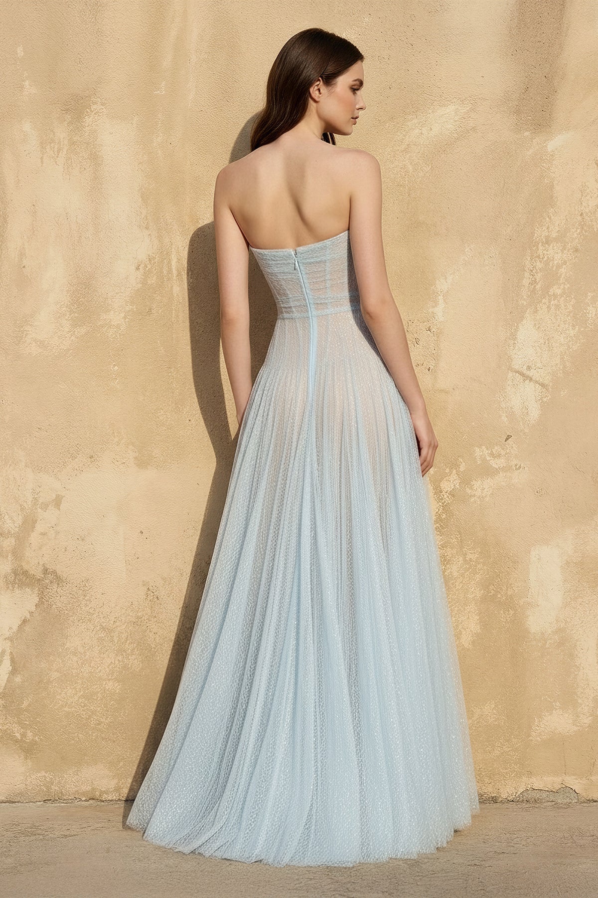 Back view of the strapless corset A-line glitter tulle gown, showing the flowing skirt.