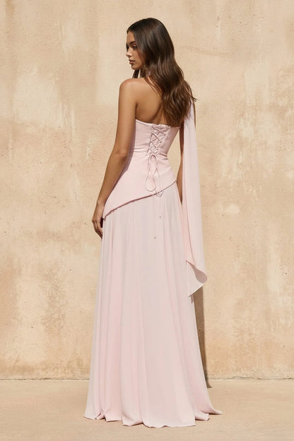 Side view of a model wearing the flowy chiffon evening dress with neck sash.