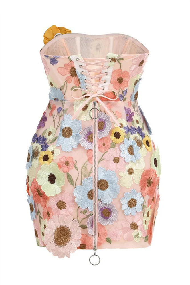 Close-up of 3D floral embroidery on Koutun pink strapless dress.