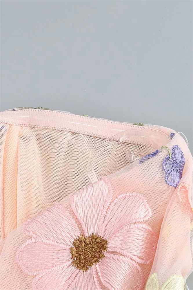 Full view of Koutun pink strapless dress with 3D floral embellishments.