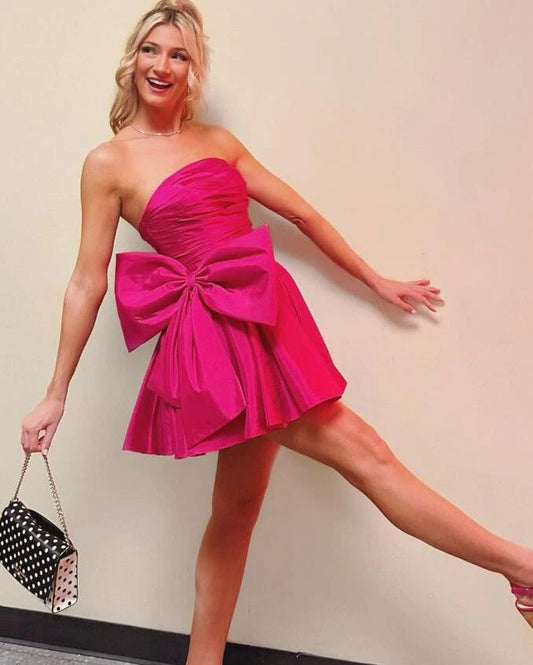 Fuchsia strapless satin pleated mini homecoming dress.