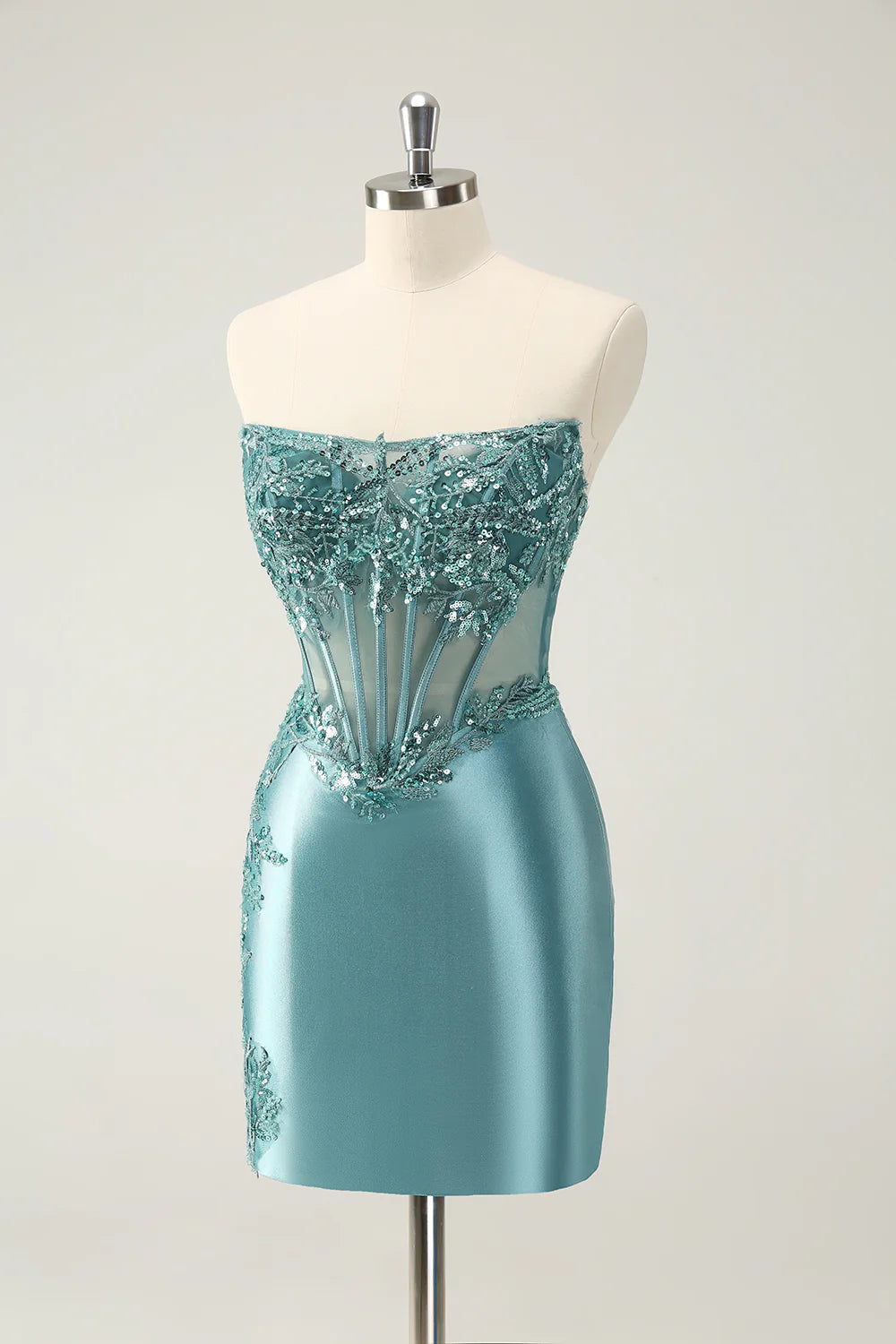 Close-up of the peacock appliques on the bodice of the formal dress.