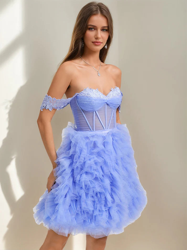 Close-up of the sweetheart neckline and intricate lace appliques on a homecoming dress.