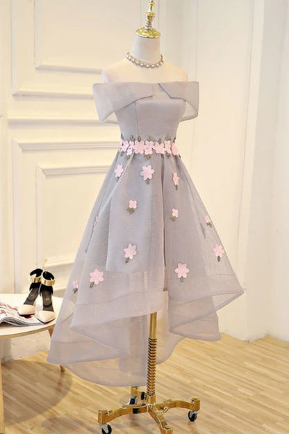Side profile of a model showcasing the light grey floral tulle high-low dress.