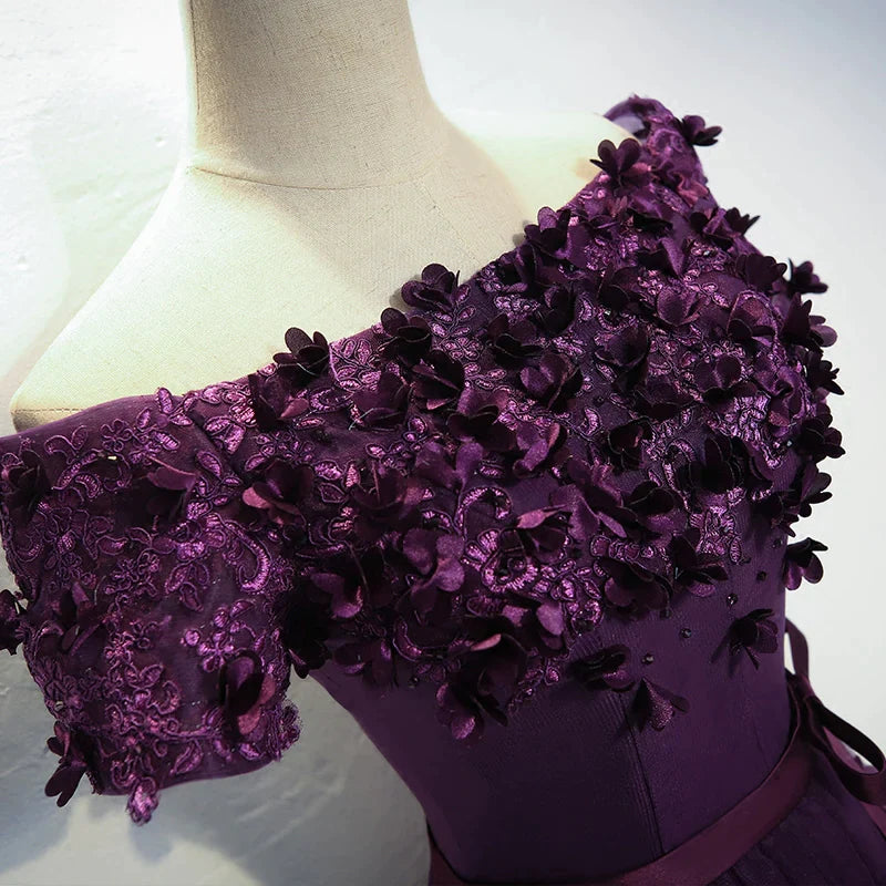 Back view of the dark purple high-low formal dress, showcasing the flowing hemline.