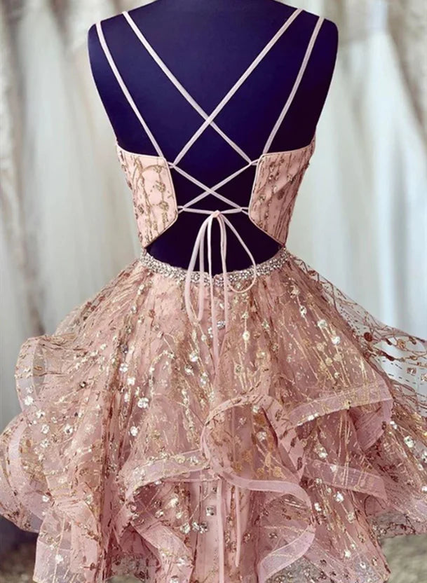 Back view of a pink tulle short prom dress showing lace-up detail.