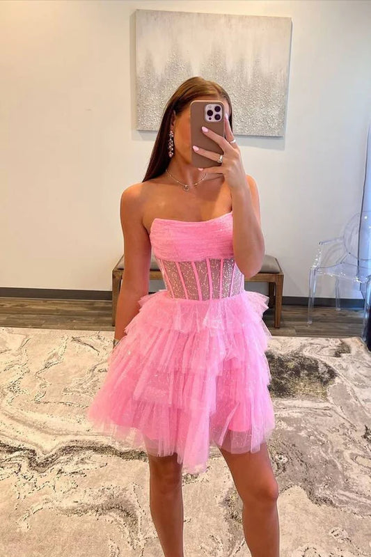 Pink tiered strapless A-line short tulle homecoming dress.