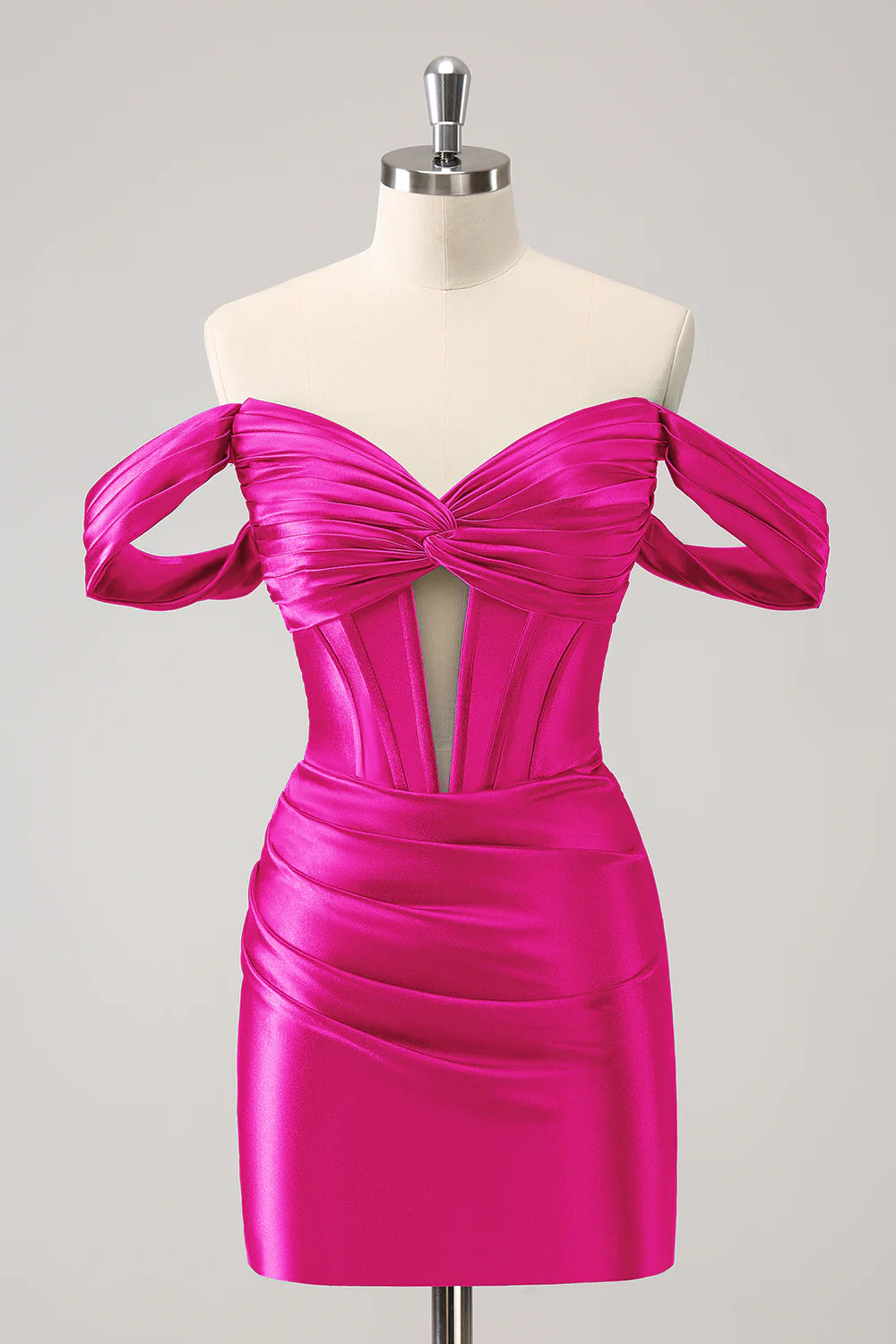 Detail of the flowing floor-length skirt of the dark green satin dress.