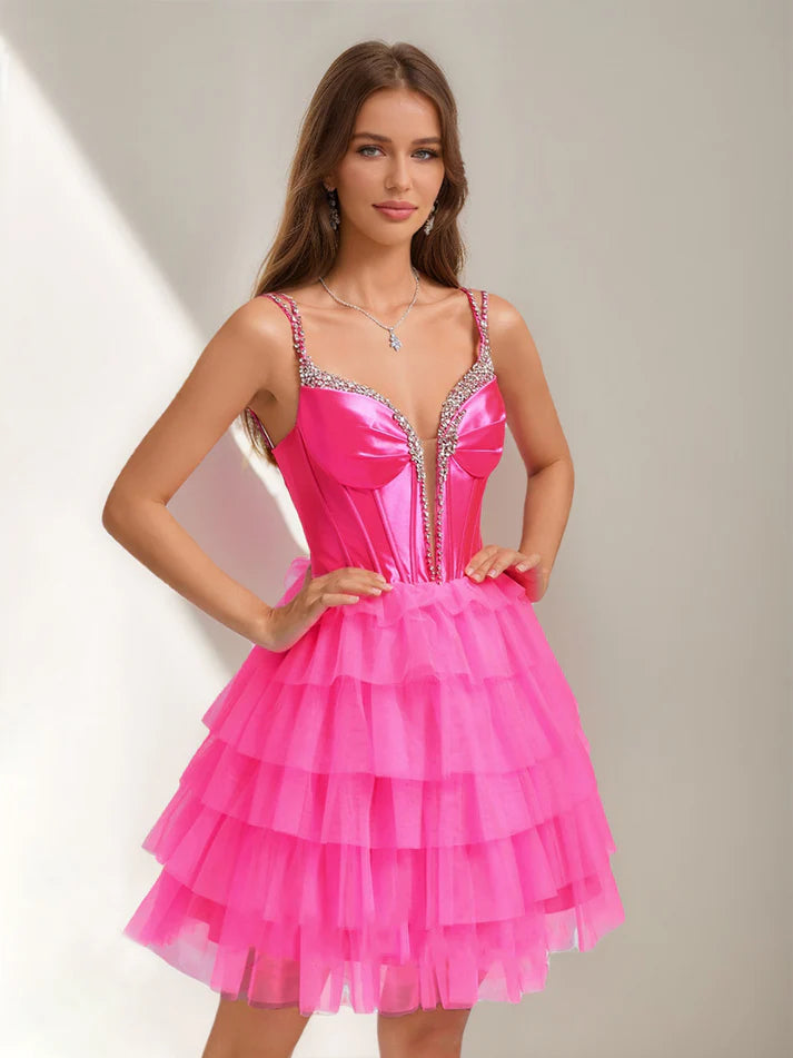 Close-up of the sparkling rhinestones and tiered ruffles on the dress.