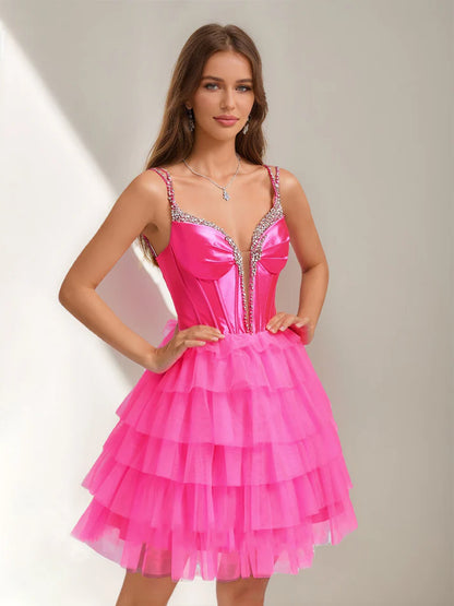 Close-up of the sparkling rhinestones and tiered ruffles on the dress.