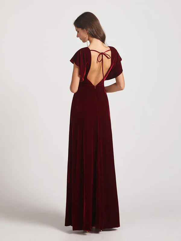 Back view of a woman in a V-neck flutter sleeve velvet bridesmaid dress.