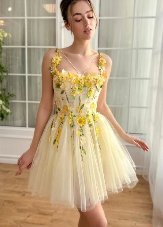 Elegant yellow short prom dress with floral appliques and sweetheart neckline.