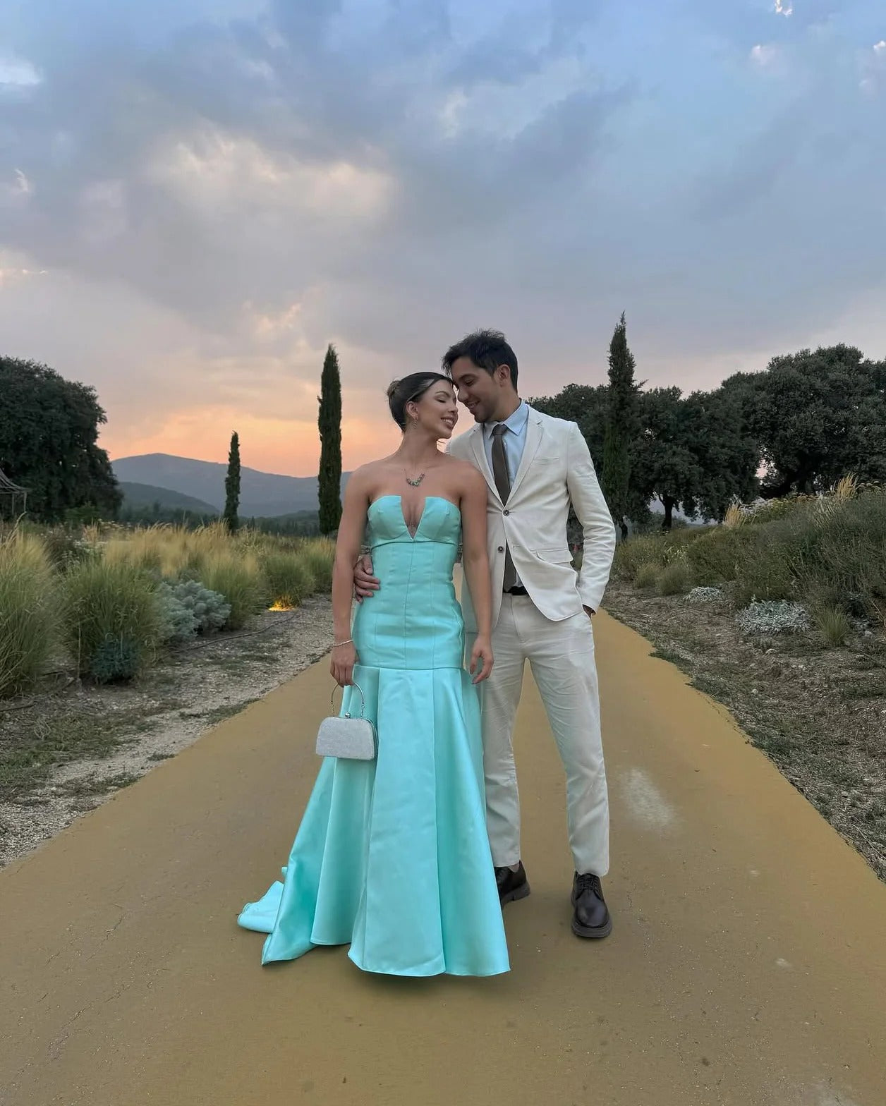 Elegant Strapless Deep V Neck Satin Mermaid Train Prom Dress with Structured Bodice and Flowing Pleated Skirt