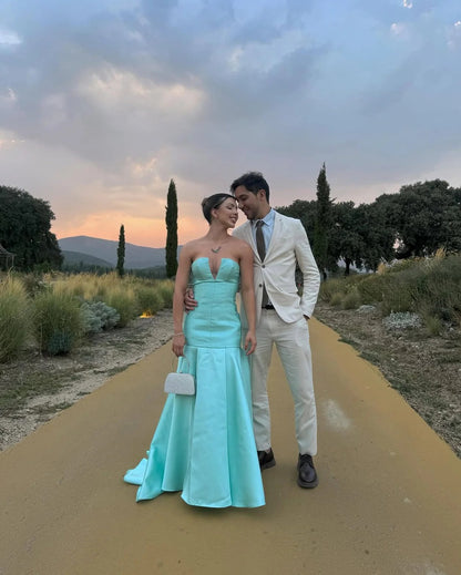 Elegant Strapless Deep V Neck Satin Mermaid Train Prom Dress with Structured Bodice and Flowing Pleated Skirt