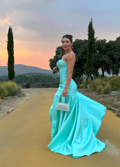 Elegant Strapless Deep V Neck Satin Mermaid Train Prom Dress with Structured Bodice and Flowing Pleated Skirt